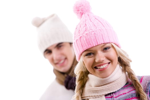 Portrait of happy girl in pink knitted cap on background of her boyfriend