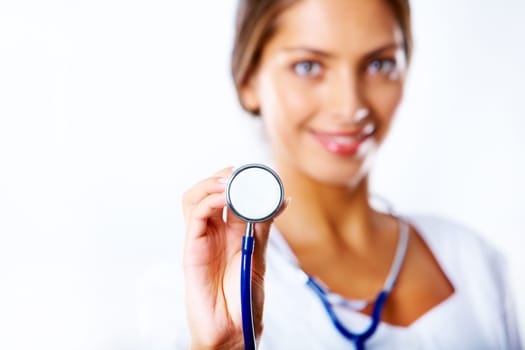 Image of stethoscope in assistants hand on background of herself