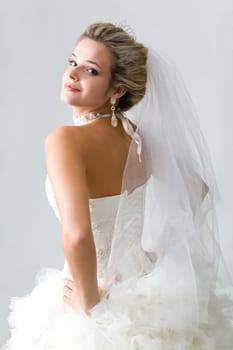 Portrait of self-confident fiancee isolated on a grey background