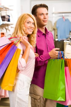 Image of woman holding by mans hand in the shop