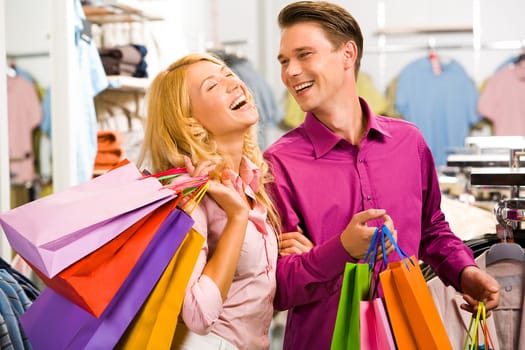 Portrait of happy woman laughing with her boyfriend near by