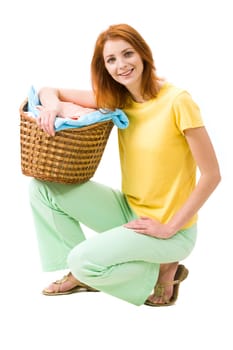 Portrait of young female with stack of colorful towels smiling to camera