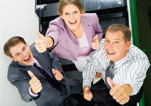Portrait of business people giving the thumbs-up sign