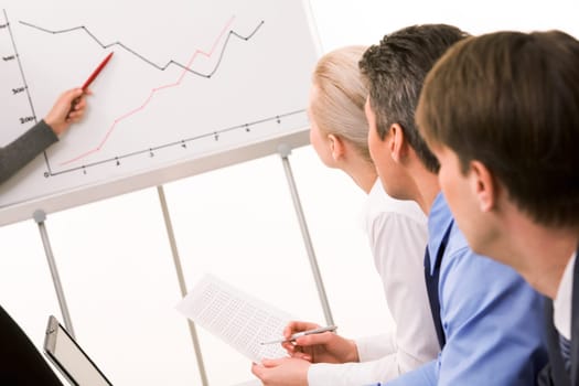 Image of business partners listening to report at working meeting