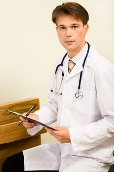 Portrait of confident doctor with stethoscope on his shoulder looking at camera