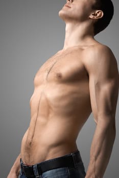 Image of handsome man with bare torso posing before camera