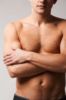 Image of shirtless man crossing his arms on chest