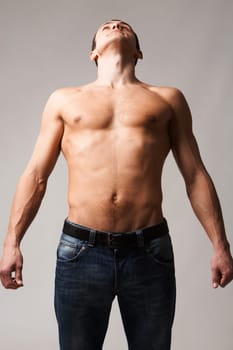 Image of shirtless man looking upwards in front of camera