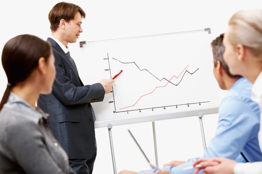 Image of confident man making presentation and pointing at graph on whiteboard