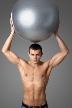 Portrait of handsome man with big ball looking at camera
