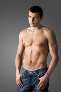 Image of handsome man with bare torso posing before camera