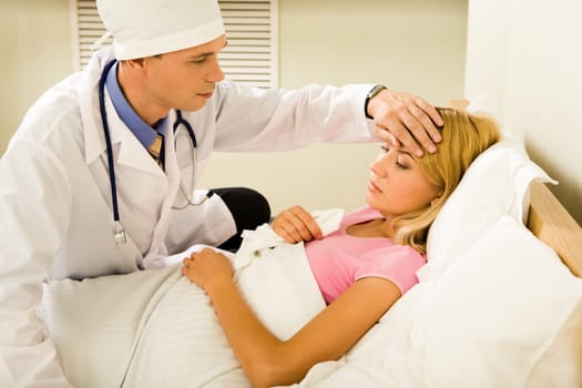 Photo of male doctor touching patient womans head in hospital