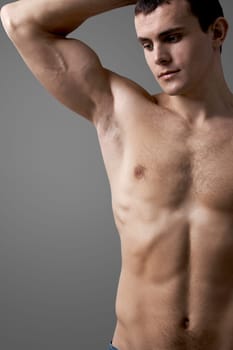 Image of handsome man with bare torso posing before camera