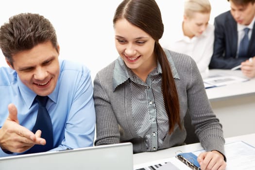 Businessman explaining computer work to a new colleague