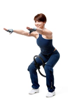 Image of sporty girl standing on the floor and doing physical exercise