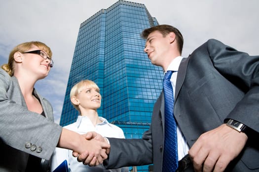 Below view of leaders handshaking after signing contract