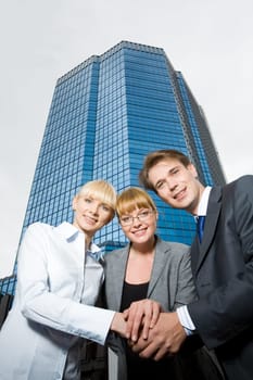 Portrait of friendly people putting their hands on top of each other