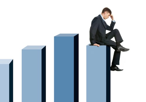 Image of pensive businessman sitting on chart columns