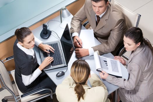 View from above of business team working at table in the office