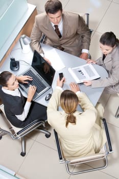 Above view of executive people communicating during meeting