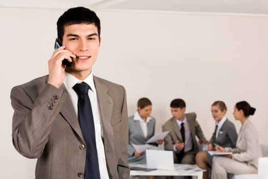 Photo of female employee speaking on the phone with smile