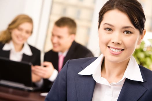 Photo of happy white collar worker looking at camera in working environment