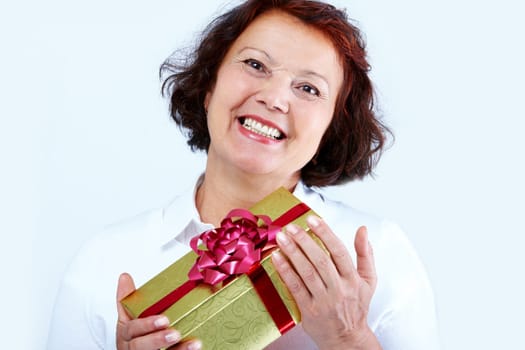 Portrait of middle-aged female with golden giftbox laughing