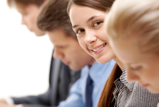 Successful businesswoman between partners looking at camera