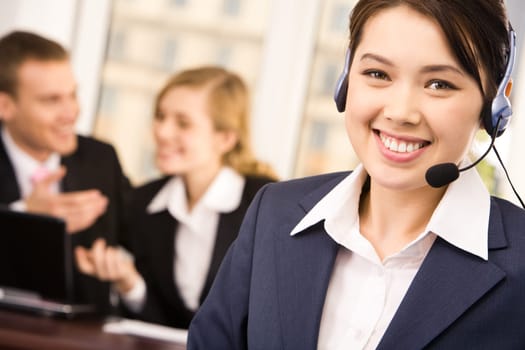Customer service representative wearing headset looking at camera with smile