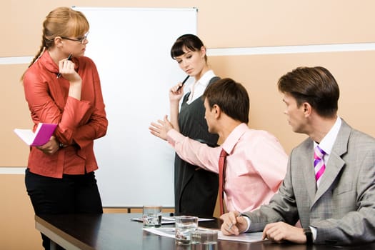 Photo of serious young man pointing at board while proving his answer at seminar