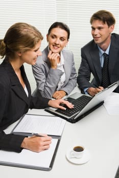 Young woman answers questions at presence of the manager and the boss
