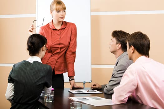 Image of smart teacher explaining new topic to students at lecture