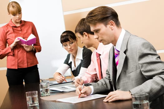 Image of business people working at seminar with their teacher standing near by