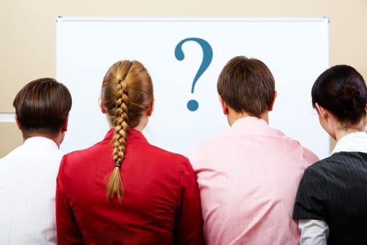 Rear view of business team with whiteboard in front of them