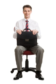 Portrait of cheerful boss sitting in armchair with case in hands