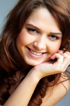 Portrait of charming girl touching her face and looking at camera