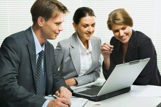 Business woman is explaining the correct way of analysis to her colleagues in  the office