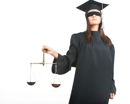 Young lawyer with closed eyes holding scales