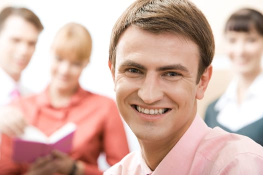 Handsome man looking at camera in working environment