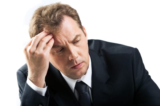 Photo of stressed businessman touching his head while thinking