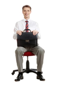 Portrait of cheerful boss sitting in armchair with case in hands