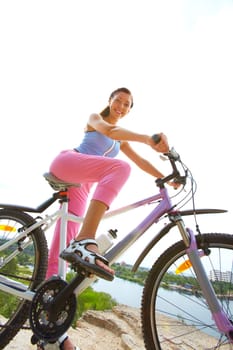 Portrait of young woman riding bicycle