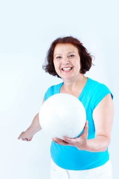 Portrait of healthy middle-aged female holding white leather ball