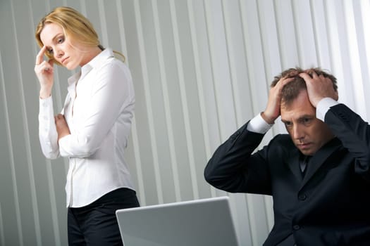 Photo of stressed businessman touching his head with sad woman near by