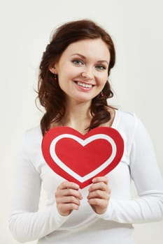 Portrait of a woman holding paper heart