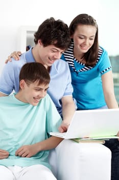 Three teenagers studying with computer