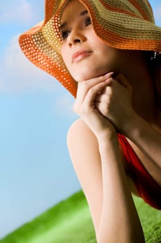 Portrait of happy woman in hat enjoying hot summer day