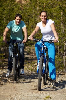Portrait of a young couple riding bicycles