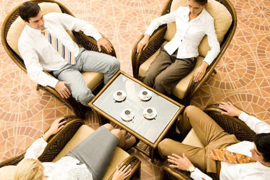 View from above of sitting business partners during negotiations in office