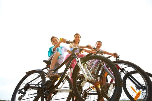 Below view of family of three riding bicycles